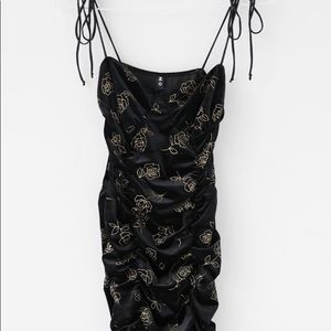 Black mini dress with gold detail
